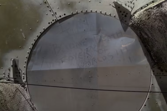 An image of the words Robert Oppenheimer quoted from the Gita, seen written in dust on part of a deactivated nuclear missile at the Pima Air & Space Museum.